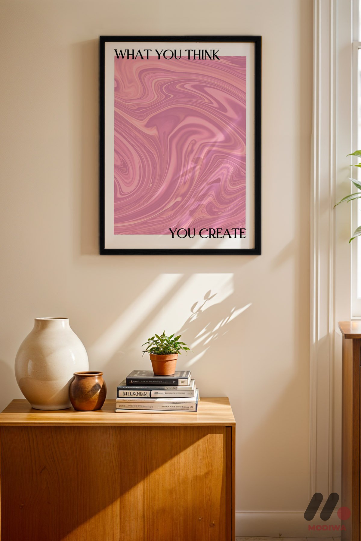 What You Think You Create Pembe siyah çerçeveli duvar tablosu, konsol üstündeki duvarda